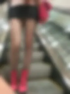Girl in a Short Skirt and Fishnet Pantyhose on the Escalator Creepshot