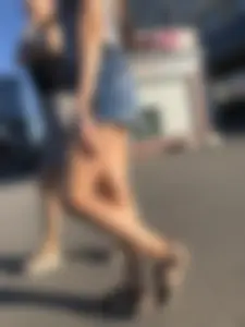 Two Hot Girls on a Street in Denim Shorts and a Skirt - One Touching Her Booty - Creepshots Gallery