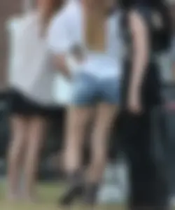 Hippie type dressed girl in denim shorts with a nice ass