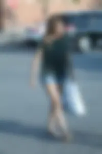 Cutie walking in the parking lot in jean shorts