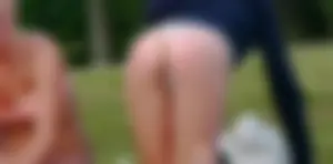 Three sexy girls in bikinis exercising at the park