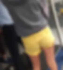 Skinny ass eating her yellow shorts