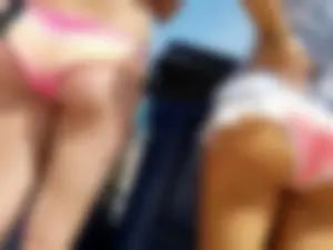 Trio of girls in bikinis on the beach and one with an incredible ass