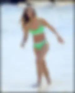 Super hot beach babe with a perfect body in a green thong bikini