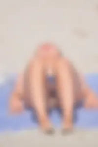 Blue bikini girl on the beach with a great ass and a little pussy lips slips