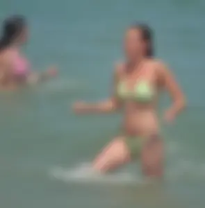 Milf at the beach in the water with hard nipples and a nice body