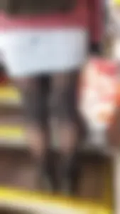 Legs in black pantyhose closeup on subway escalator creepshot