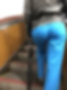 Booty of a candid girl standing on subway escalator low angle creepshots