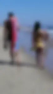 Beach babe with a nice ass and big tits in yellow thong bikini