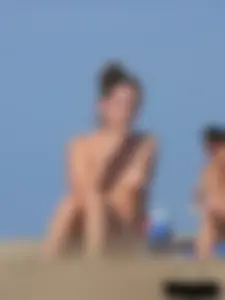 Sexy babe with a nice body topless and in a thong on the beach