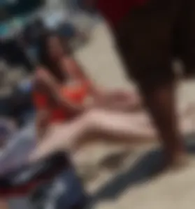 Beach girl with big boobs in an orange swimsuit