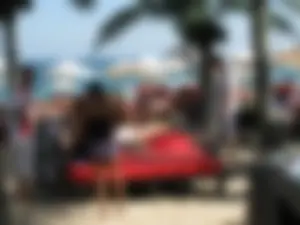 Topless cutie at the beach with a tight little ass in a thong