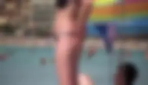 Amazing ass in semi-thong bikini on the beach with tanlines