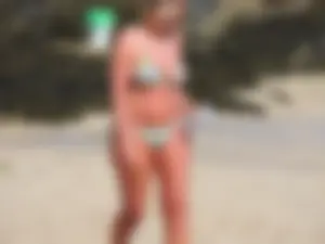 Blonde milf on the beach in her bikini
