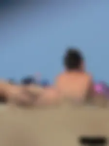 Sexy babe with a nice body topless and in a thong on the beach