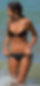Tight bodied skinny brunette on the beach in a bikini
