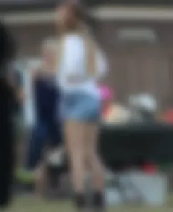 Hippie type dressed girl in denim shorts with a nice ass