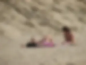 Topless beach girl with nice titties with her friend in a bikini