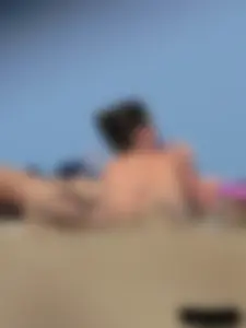 Sexy babe with a nice body topless and in a thong on the beach
