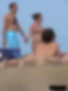 Sexy babe with a nice body topless and in a thong on the beach