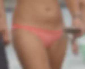 Peach bikini tattood babe on the beach with a nice ass and some camel toe