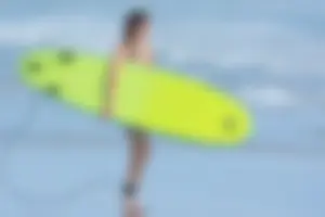 Candid girls surfing on the beach