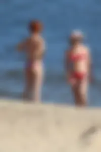 Couple of hot babes hanging out at the beach in bikinis