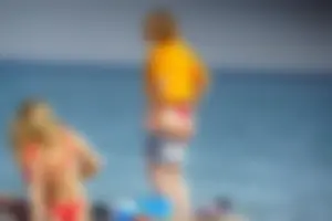Hot blonde with a slammin body in red thong bikini on the beach