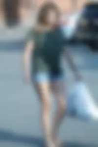 Cutie walking in the parking lot in jean shorts