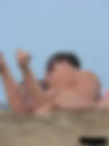 Sexy babe with a nice body topless and in a thong on the beach