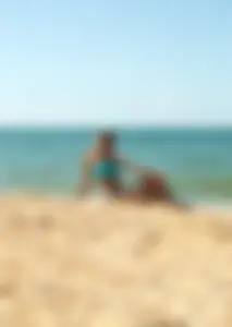 Sexy blonde milf on the beach in blue thong bikini and showing nice camel toe