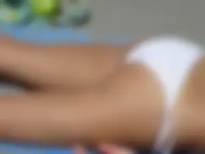 Sexy beach girl laying out in white bikini with nice body