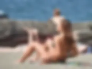 Beach babe taking off her shorts and shirt showing her bikini and sexy body
