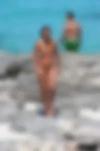 Older lady on a nude beach showing her body
