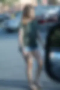 Cutie walking in the parking lot in jean shorts