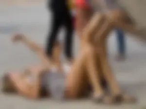 Girl in Short Dress and Sandals Lying on the Pavement Creepshot