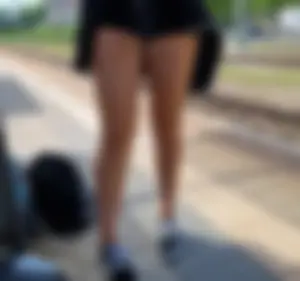 A Hot Candid Girl in Mini-Shorts And Sneakers Sitting on the Floor at the Railway Station Creepshots Gallery