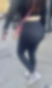 Latina BBL adjusting her leggings