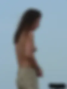 Sexy babe with a nice body topless and in a thong on the beach
