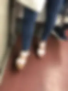 Candid girl wearing tight blue jeans and sandals on high platforms
