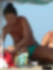 Bunch of sexy babes on the beach topless and in thong bikinis