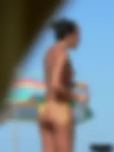 Bunch of sexy babes on the beach topless and in thong bikinis