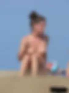 Sexy babe with a nice body topless and in a thong on the beach