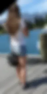 Pretty girl with a camera in little denim shorts