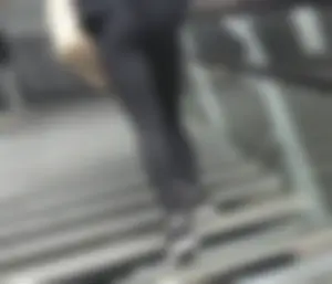 Skinny candid girl in tights walking up the stairs low angle creepshot