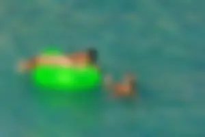 FKK Nudists playing in the water with floater