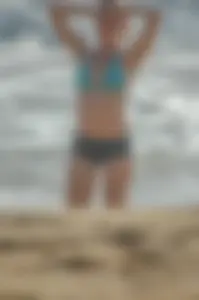 Blonde lady on the beach in bikini top and spandex shorts with a nice gap