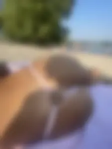 Awesome booty in strings at the beach closeup