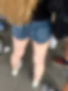 Awesome firm butt in blue denim mini-shorts and perfect legs closeup