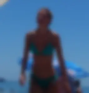 Sexy blonde on the beach in a teal thong bikini with nice ass